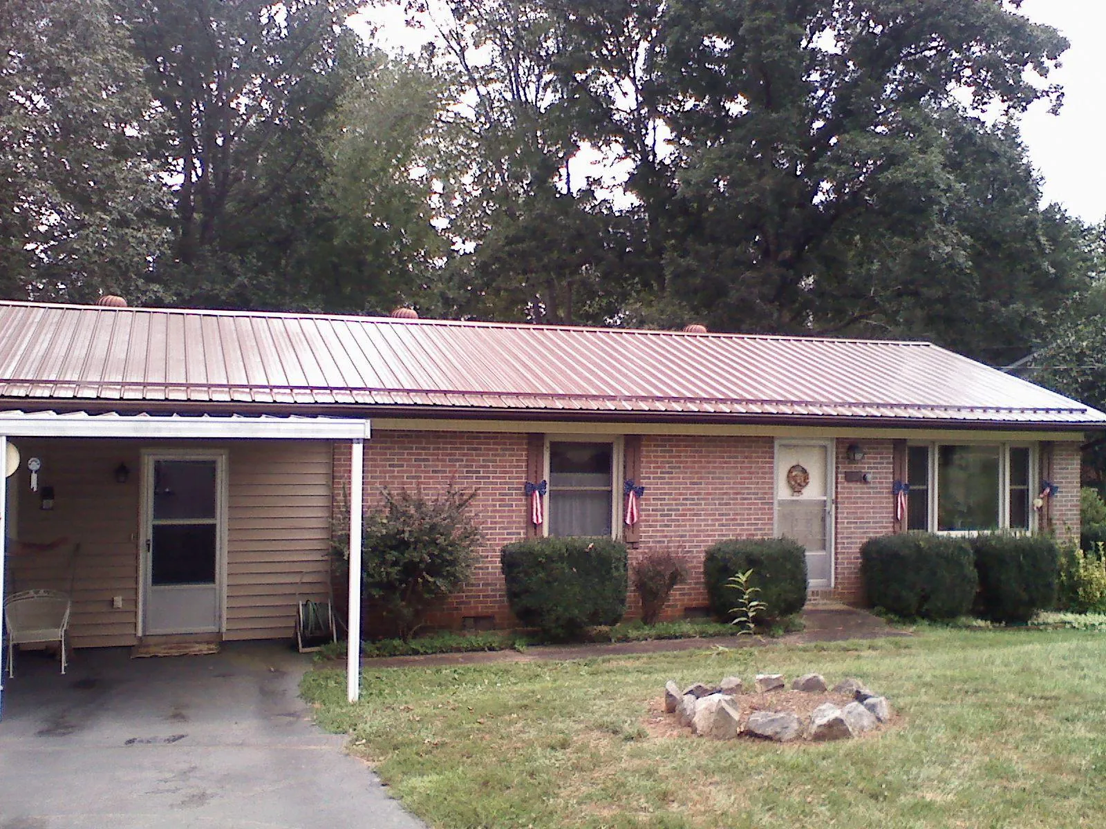 Bronze metal roof and carport on a brick ranch home — Roof Repair work by our crew in Brandy Station